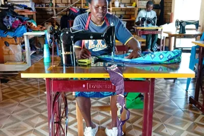  A beneficiary operates a sewing machine during a community skills development initiative aimed at promoting youth employment and economic empowerment.